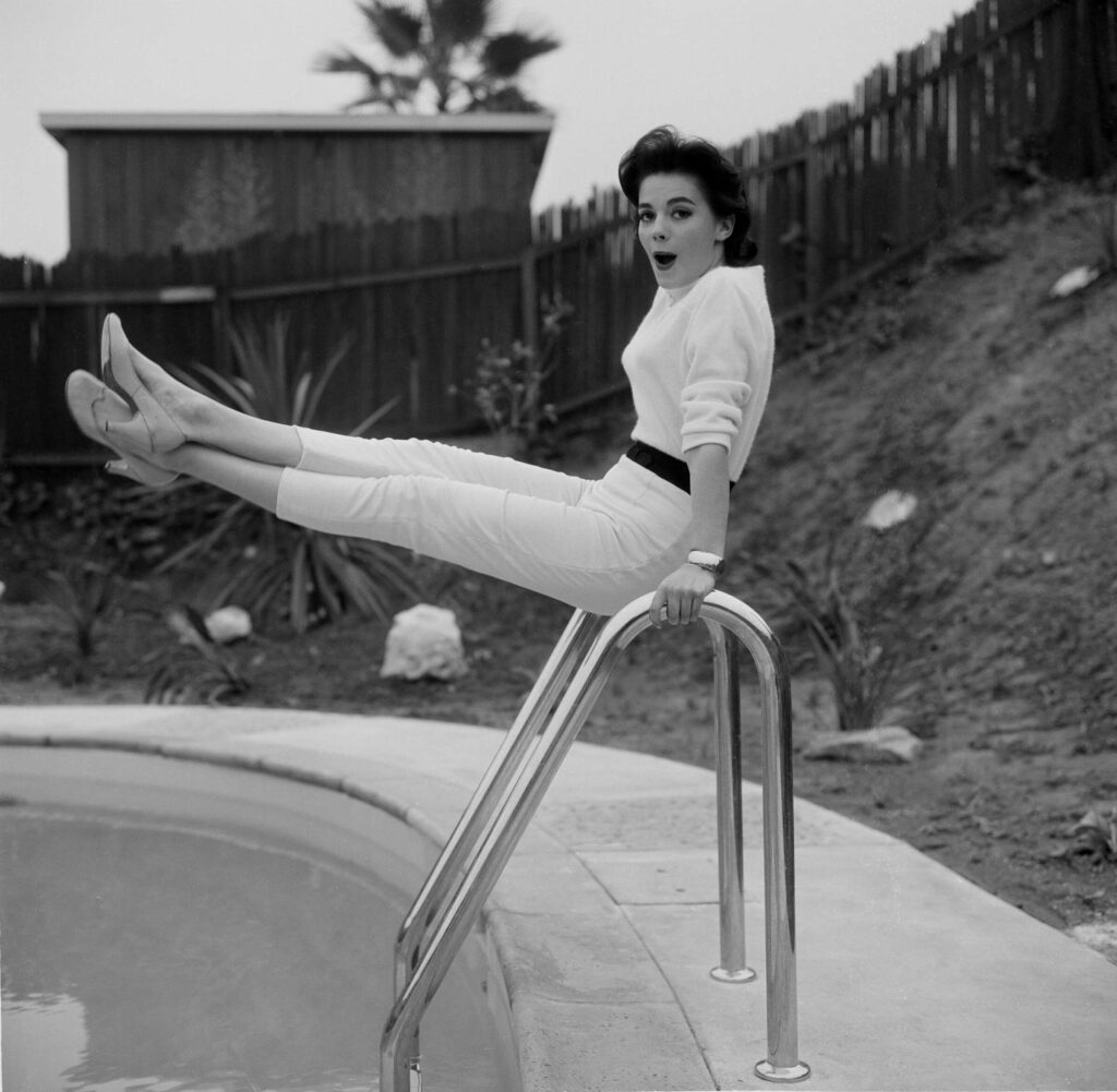 Natalie Wood poses by her swimming pool