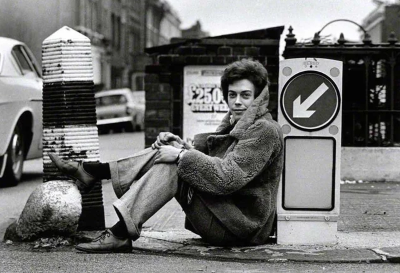 Tim Curry lounging on the streets of London, 1969